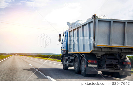 Transporting waste in a dump truck on the highway for recycling. Transportation of recyclable materials to a processing plant. Copy space for text, industry 82947642