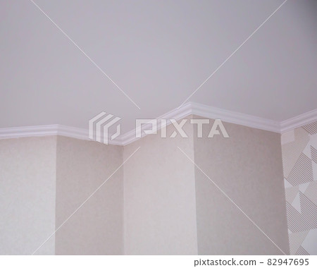Wall with different angles and skirting boards in the room. Design solution for renovation in an apartment. Copy space for text Wall with different angles and skirting boards in the room. Design solution for renovation in an apartment. Copy space for text 82947695