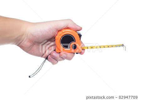 Man engineer holding a measuring tape in his hand on a white background, isolate. Close-up, centimeter Man engineer holding a measuring tape in his hand on a white background, isolate. Close-up, centimeter 82947709