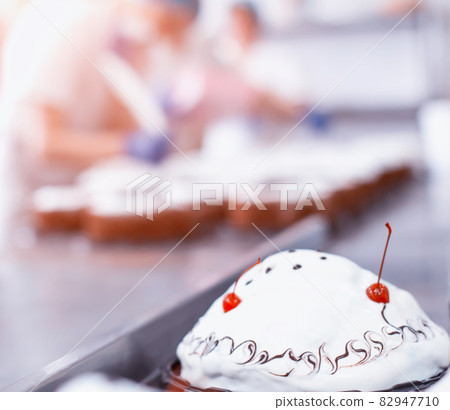 Mass production of cakes and sweets at the confectionery factory. Chefs make cakes of fresh berries and biscuit, food industry, copy space 82947710