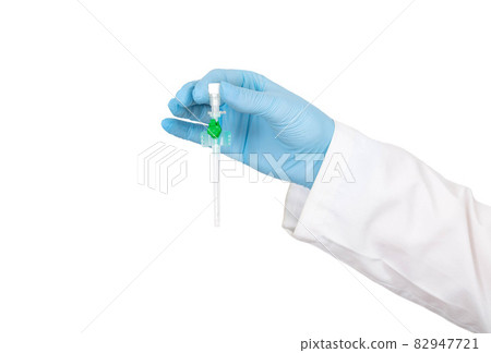 Doctor's hand in a medical gown and a blue glove with a medical catheter on a white background, isoyal. Concept for the use of catheters in plastic surgery Doctor's hand in a medical gown and a blue glove with a medical catheter on a white background, isoyal. Concept for the use of catheters in plastic surgery 82947721