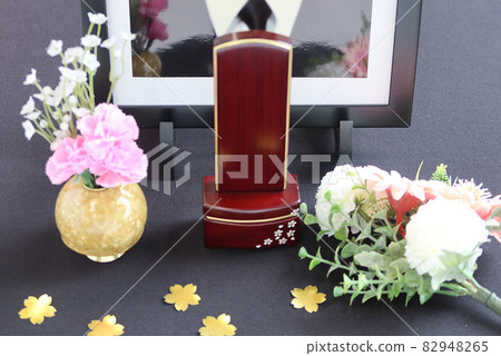 A modern mortuary tablet and flower arrangement in front of the portrait of the deceased 5 Image of Shukatsu 82948265