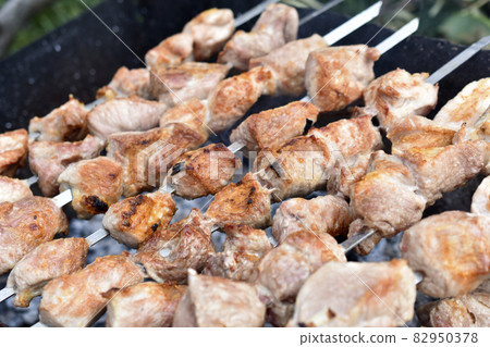 Delicious barbecue of hot pork on a spit 82950378