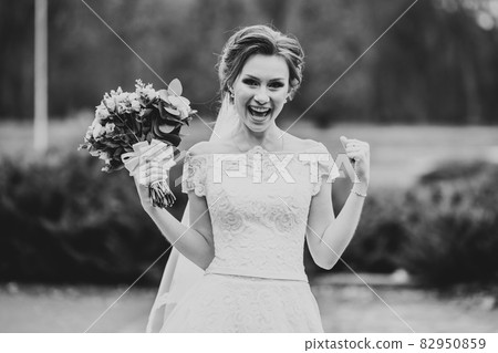 Portrait of stunning bride with long hair posing with great bouquet 82950859