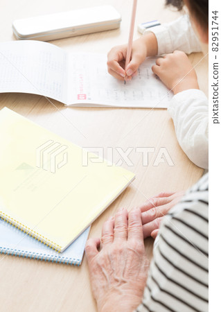 Grandmother teaching with a child doing homework Grandmother teaching with a child doing homework 82951744