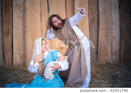Biblical characters taking a selfie in a nativity scene 82951798