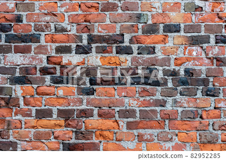 Fragment of a wall made of old bricks. 82952285