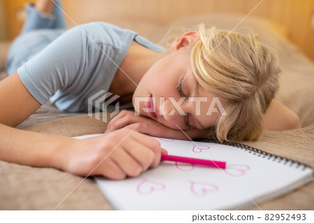 A cute blonde girl napping and looking peaceful 82952493