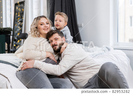 Happy family concept Mother father and son have fun at home 82953282
