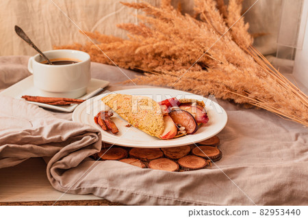 Gluten-free keto Crepes filled with pear, walnut and cinnamon in the oven with sea buckthorns on top. Autumn vegetarian breakfast or healthy dessert concept. Gluten-free keto Crepes filled with pear, walnut and cinnamon in the oven with sea buckthorns on top. Autumn vegetarian breakfast or healthy dessert concept. 82953440