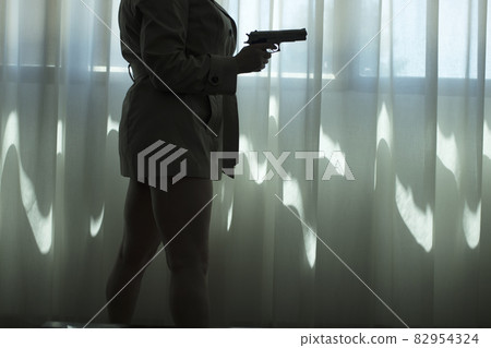 Pistol gun on table in room 82954324