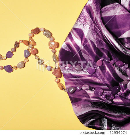 Flat lay fashion set: necklace and scarf on pastel 82954974