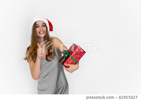 Happy smiling positive Santa woman hold gift box while gestures thumb up doing excellent. Celebrate. Happy smiling positive Santa woman hold gift box while gestures thumb up doing excellent. Celebrate. 82955027