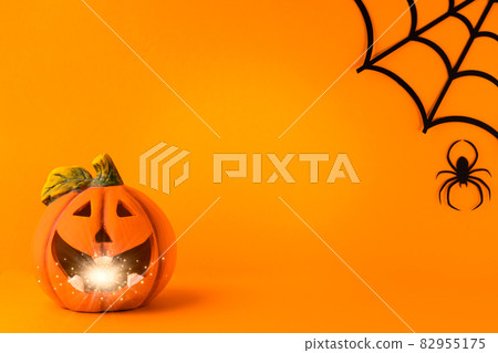 Happy halloween holiday concept. Jack o lantern, handmade paper decorations, spiders, web, ghosts on orange background. Halloween festival party, greeting card mockup with copy space Happy halloween holiday concept. Jack o lantern, handmade paper decorations, spiders, web, ghosts on orange background. Halloween festival party, greeting card mockup with copy space 82955175