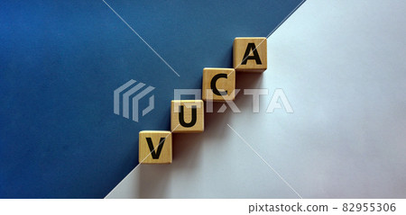 VUCA symbol. Wooden cubes with word 'VUCA - volatility, uncertainty, complexity, ambiguity'. Beautiful white and blue background, copy space. Business and VUCA concept. VUCA symbol. Wooden cubes with word 'VUCA - volatility, uncertainty, complexity, ambiguity'. Beautiful white and blue background, copy space. Business and VUCA concept. 82955306