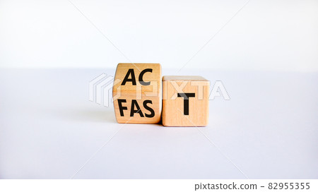 Time to act fast symbol. Turned a wooden cube with words 'act fast'. Beautiful white table, white background, copy space. Business and act fast concept. 82955355