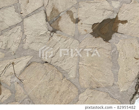 Texture of old stones of various forms with seams. Close up of shabby masonry. Stone wall from uneven different ancient friable cobblestones Texture of old stones of various forms with seams. Close up of shabby masonry. Stone wall from uneven different ancient friable cobblestones 82955482