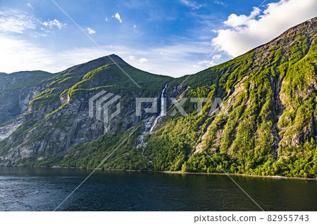 Impression from cruise ship on the way through Geiranger fjord in Norway at sunrise in summer Impression from cruise ship on the way through Geiranger fjord in Norway at sunrise in summer 82955743