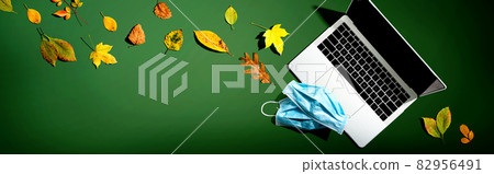 Laptop computer with masks in autumn Laptop computer with masks in autumn 82956491