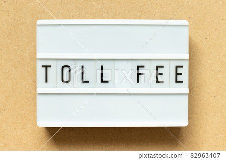 Lightbox with word toll fee on wood background Lightbox with word toll fee on wood background 82963407