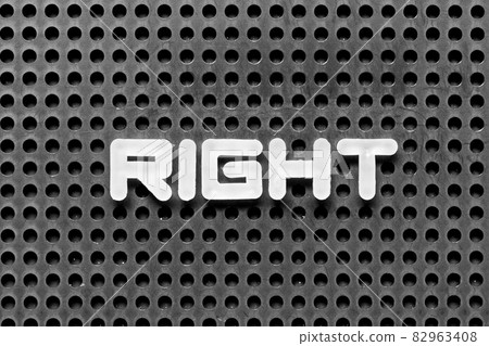 White alphabet letter in word right on black pegboard background White alphabet letter in word right on black pegboard background 82963408