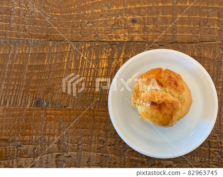 Scones on a wooden table and white plate 82963745