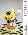 Wool felt tiger sleeping on a kotatsu 82965043