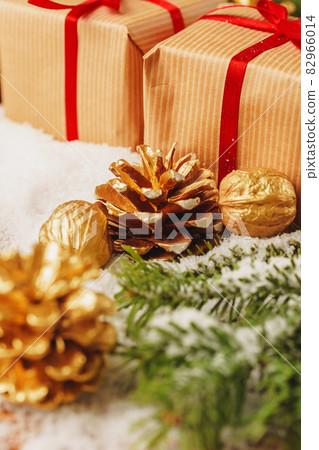 Decorated present on snowy wooden table close up 82966014