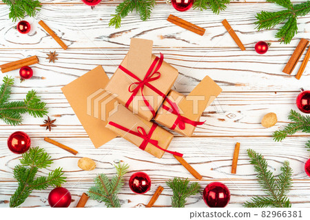 Wrapped present on a wooden background with Christmas holiday decorations top view 82966381