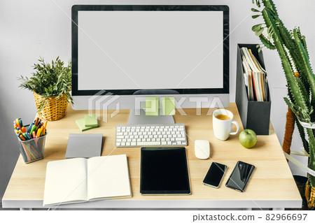 Computer monitor with mockup white screen on office table with supplies Computer monitor with mockup white screen on office table with supplies 82966697