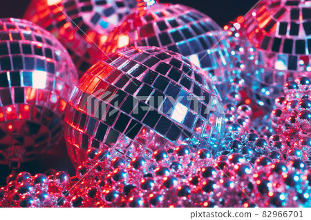 Shiny disco party background with mirror balls reflecting light Shiny disco party background with mirror balls reflecting light 82966701