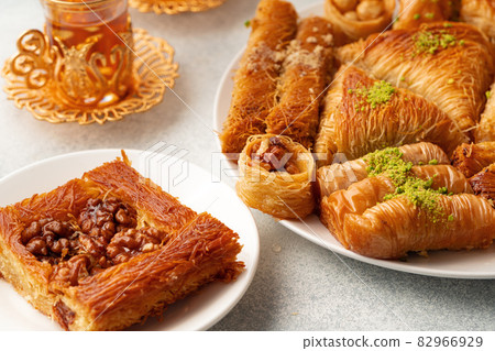 Various Turkish sweets and cup of tea on white textured background 82966929