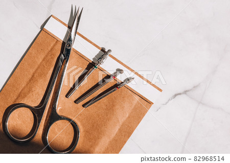 Clean manicure instruments. Manicure set in paper heat dry bag for sterilization. Sterilization of instruments healthcare concept Clean manicure instruments. Manicure set in paper heat dry bag for sterilization. Sterilization of instruments healthcare concept 82968514