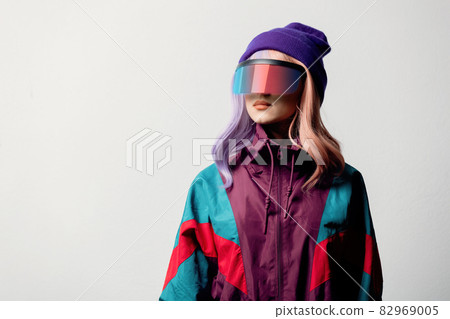 Beautiful woman in VR glasses and 80s sport suit on white background 82969005
