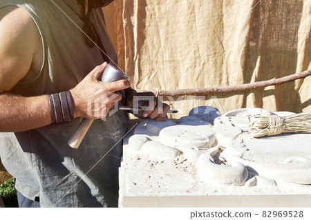 Craftsman carving stone in a traditional way. Concept of traditional 82969528