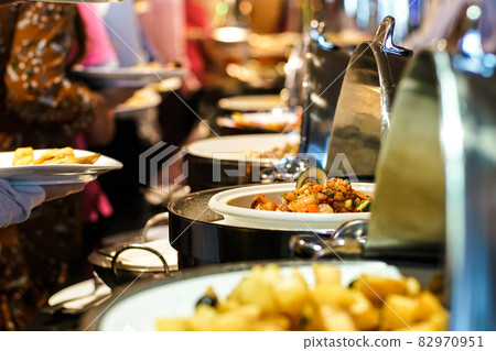 Hand of people take buffet food in hotel party 82970951