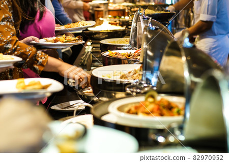 Hand of people take buffet food in hotel party Hand of people take buffet food in hotel party 82970952