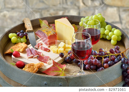 Hearty South Tyrolean snack with smoked bacon, tasty cheese,  crunchy rye bread and red wine 82971081