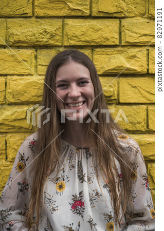 Close-up portrait of pretty young woman in casual dress smiling with the teeth. Straight long blond hair. Natural beauty without make-up Close-up portrait of pretty young woman in casual dress smiling with the teeth. Straight long blond hair. Natural beauty without make-up 82971191
