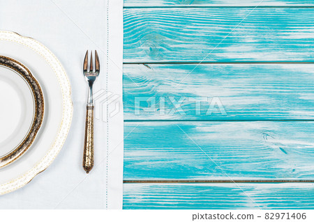 Flat lay of dishware and cutlery on wooden background 82971406