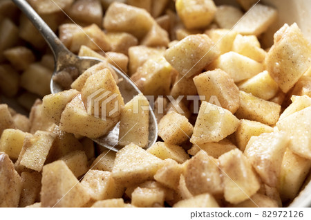 Cutted and peeled apples, close up. Cooking an apple pie or tart. Step by step recipe. Cutted and peeled apples, close up. Cooking an apple pie or tart. Step by step recipe. 82972126
