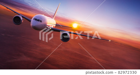 Commercial airplane flying above clouds. 82972330
