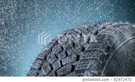 Freeze Motion of Car Tire with Icing and Falling Snow. Freeze Motion of Car Tire with Icing and Falling Snow. 82972472