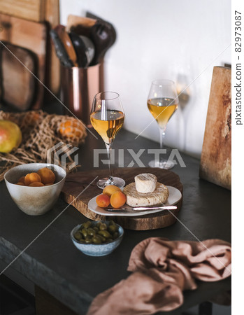 Orange wine in glasses, fruits and cheese on Orange wine in glasses, fruits and cheese on 82973087