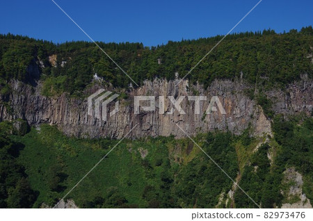 Columnar joint cliffs and stone droppings seen from Midama Park, Tsunan Town Columnar joint cliffs and stone droppings seen from Midama Park, Tsunan Town 82973476