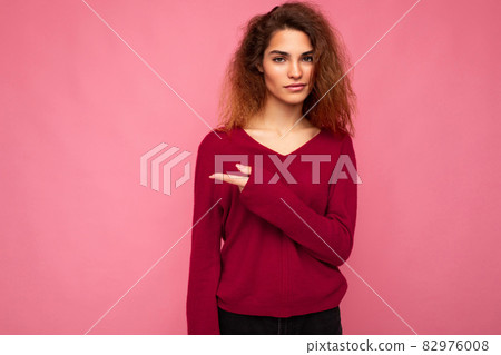 Photo of young beautiful brunette wavy woman with sincere emotions wearing casual pink sweater Photo of young beautiful brunette wavy woman with sincere emotions wearing casual pink sweater 82976008
