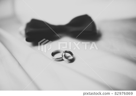 Set of mans fashion shoes with two golden wedding rings 82976869