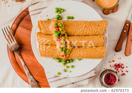 Homemade Coconut flour and turmeric keto wraps with cottage cheese sauce. Low-carb gluten free crepe with curry sauce and sweet corn and green peas on top Homemade Coconut flour and turmeric keto wraps with cottage cheese sauce. Low-carb gluten free crepe with curry sauce and sweet corn and green peas on top 82978373