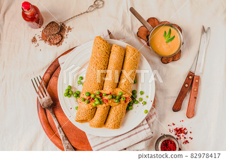 Gluten free crepes from corn, rice flour and potato starch with curry sauce 82978417