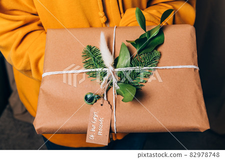 Hands are holding gift in eco paper 82978748